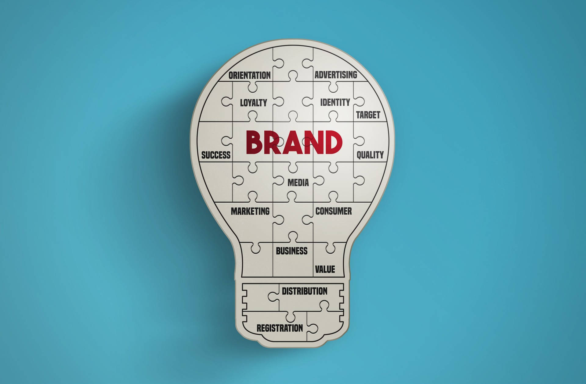 Light bulb puzzle pieces forming the word Brand on blue background.